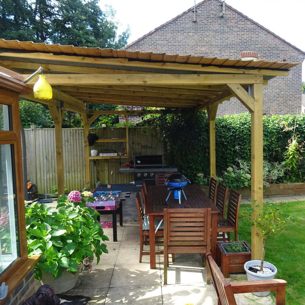 Hand-built timber pergola over a garden dining area, built by Cordreys in West Sussex